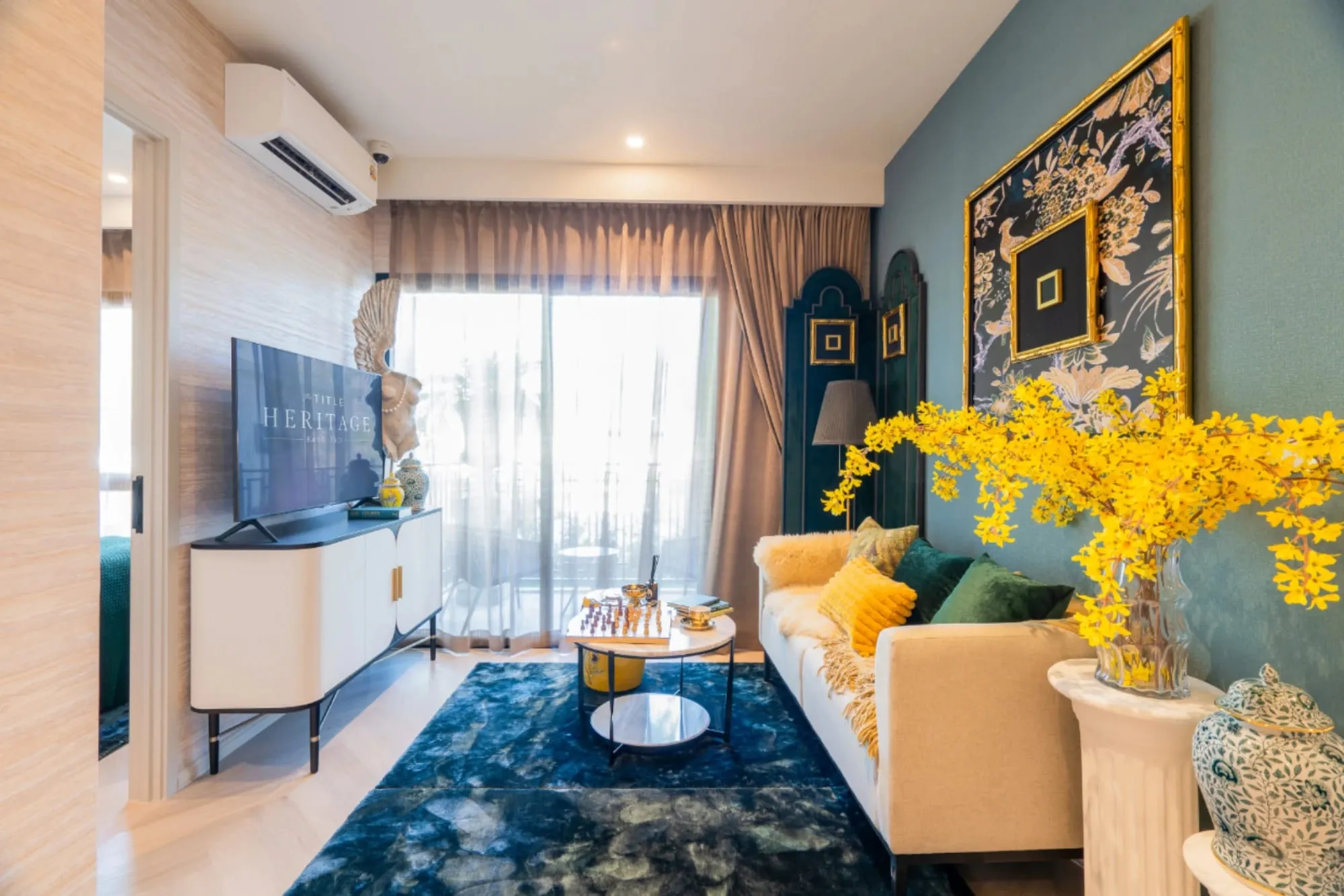 Show unit living room with teal walls