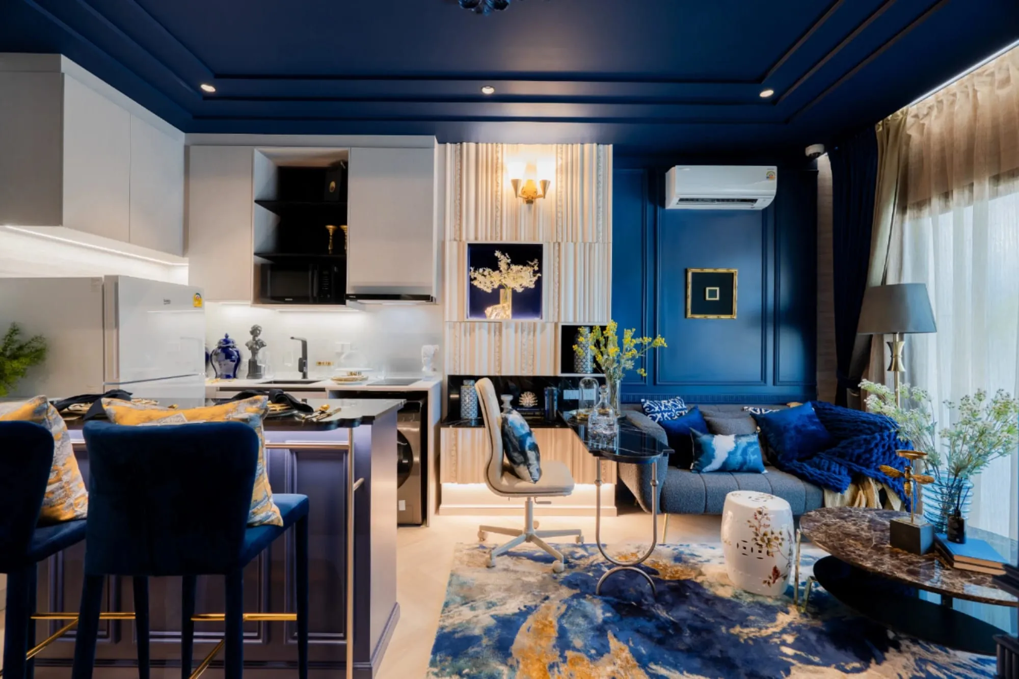 Show unit with navy kitchen and dining area